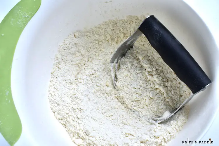 Cutting in butter into flour mixture with a pastry cutter