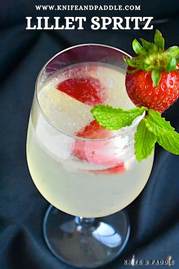 Lillet Spritz with crushed ice and strawberries and mint sprig for garnish