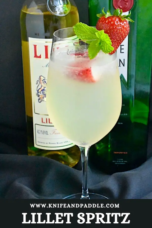 Lillet Spritz with crushed ice and strawberries and mint sprig for garnish