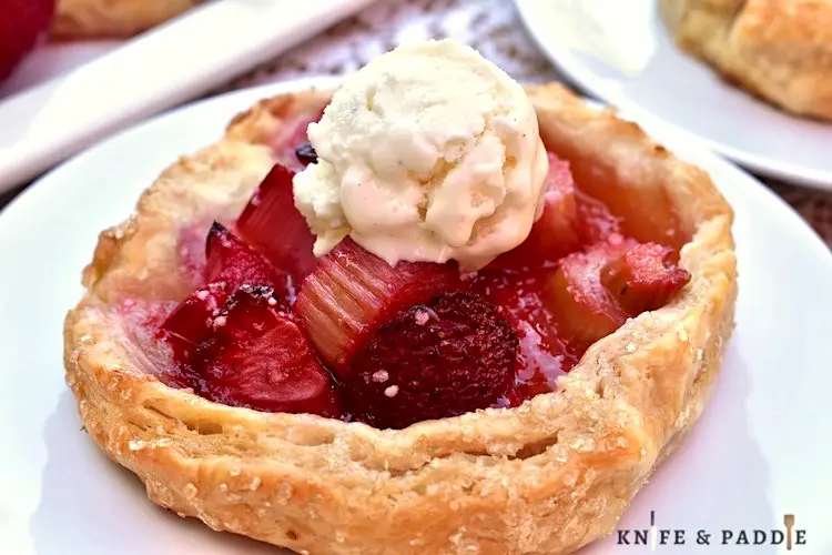 Mini Strawberry Rhubarb Galette on a plate with a scoop of ice cream