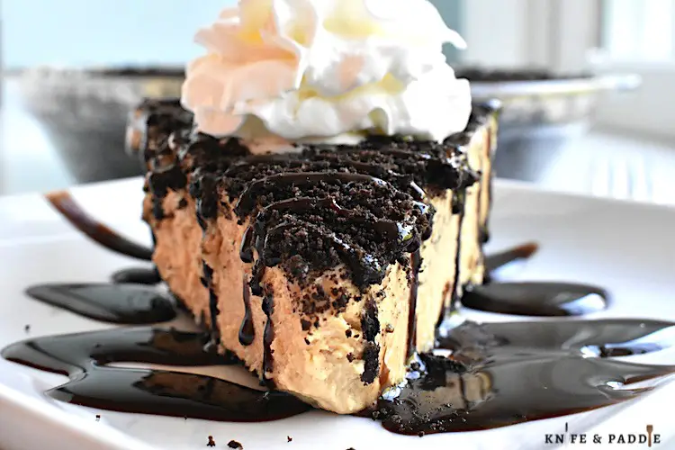 Creamy Peanut Butter Pie with crushed Oreos topped with chocolate drizzle and whipped cream