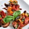 Grilled Bruschetta on a plate with fresh basil and balsamic glaze