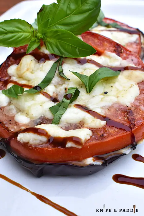 Grilled Eggplant Parmesan Stacks with balsamic glaze and fresh basil topped with mozzarella and parmesan