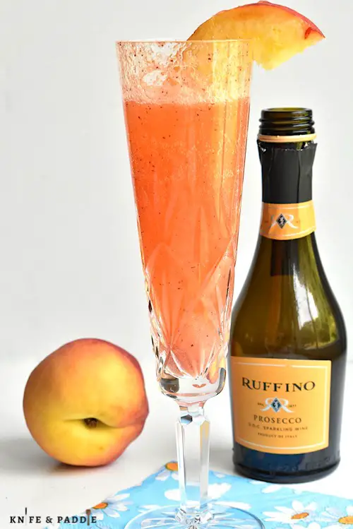 Easy peach Prosecco cocktail in a Champagne glass