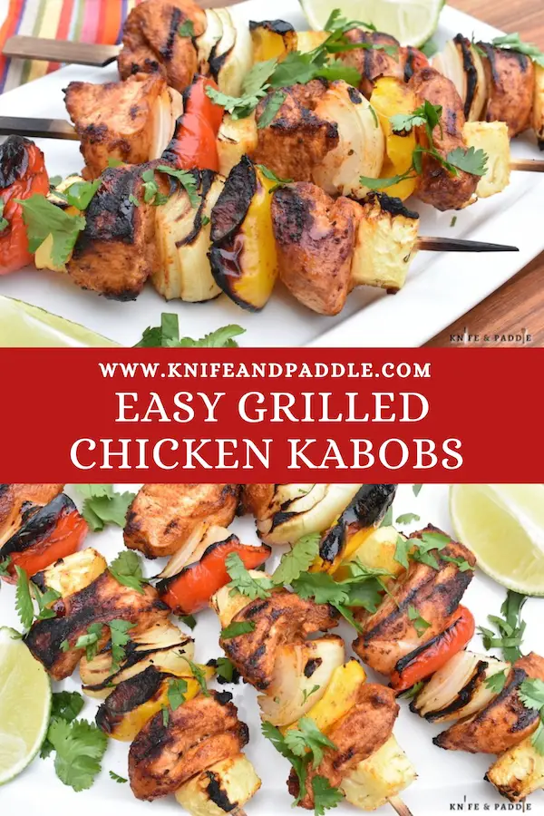 BBQ recipe with pineapple, onions and peppers on skewers topped with fresh cilantro