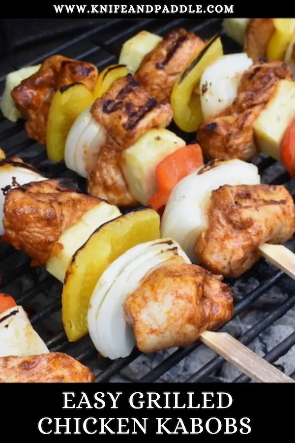 BBQ recipe with pineapple, onions and peppers on skewers topped with fresh cilantro