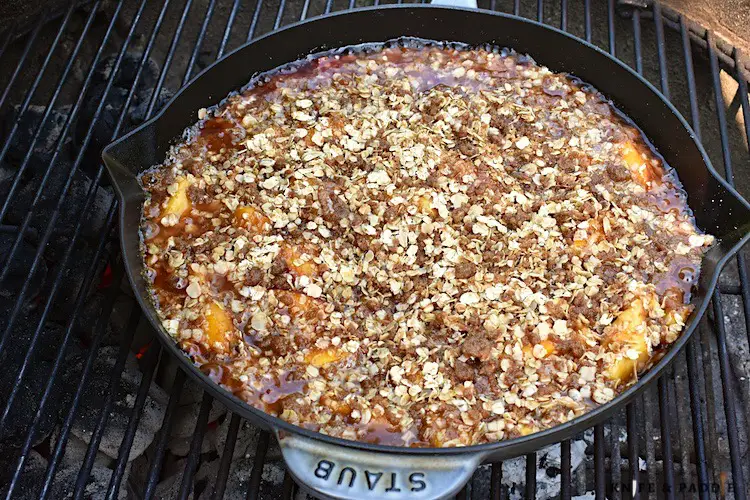 Grilled Peach Crisp in a skillet on a grill