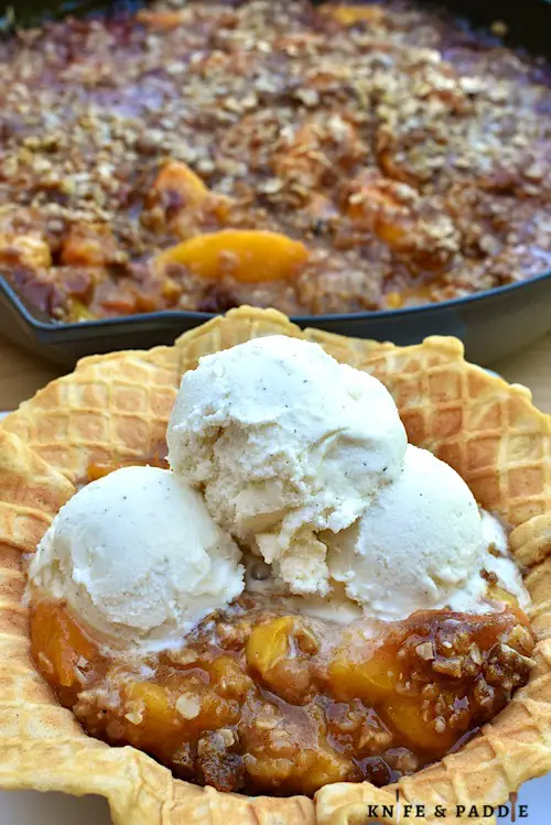 Grilled Peach Crisp Sundaes in a waffle bowl topped with vanilla ice cream