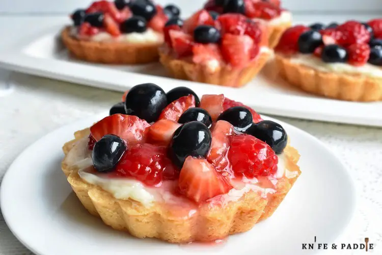 Mini Fruit tarts on a plate with fruit glaze