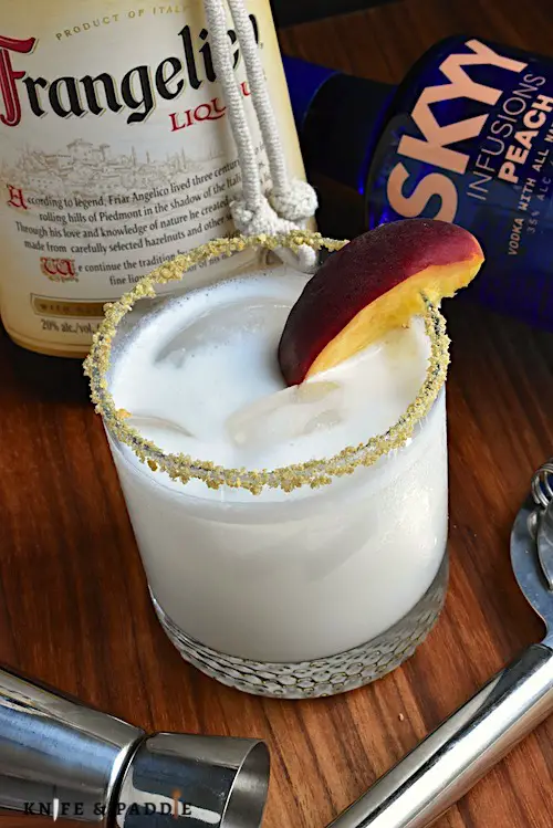 Frangelico, peach vodka, heavy cream and simple syrup shaken and pour into a prepared glass with ice, garnished with a graham cracker and brown sugar rim and a peach slice