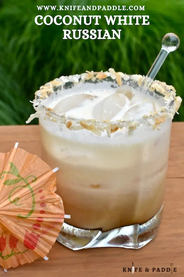 Coconut White Russian in a rocks glass filled with ice and rimmed with toasted coconut 