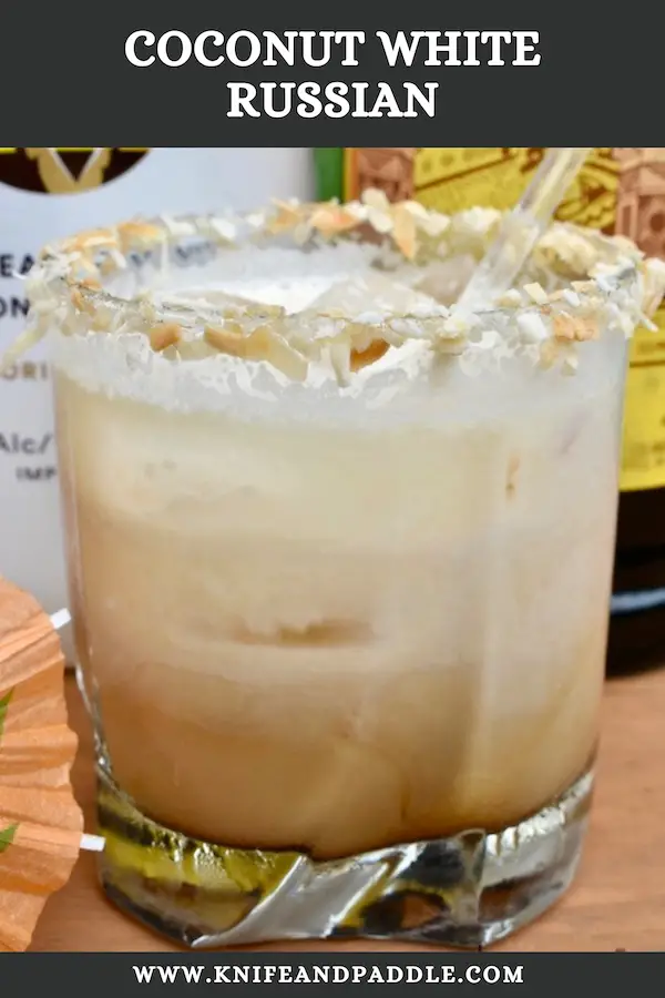 Coconut White Russian in a rocks glass filled with ice and rimmed with toasted coconut 