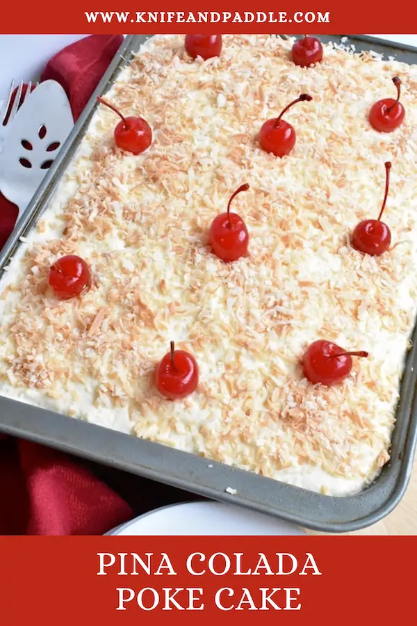 Tropical dessert made with a yellow box cake topped with a crushed pineapple and whipped topping frosting, toasted coconut and a maraschino cherry