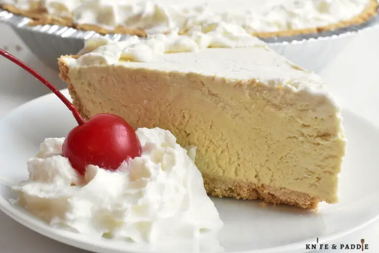 Root Beer Float Pie topped with whipped cream and a maraschino cherry