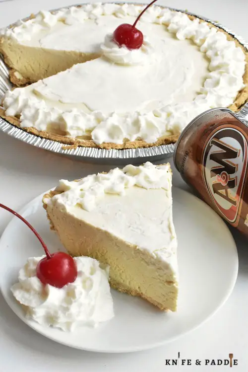 Root Beer Float Pie topped with whipped cream and a maraschino cherry