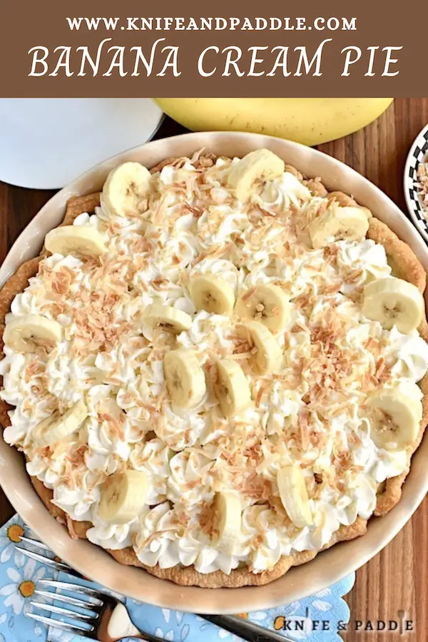 Classic Banana Cream Pie topped with homemade whipped cream, fresh bananas and toasted coconut