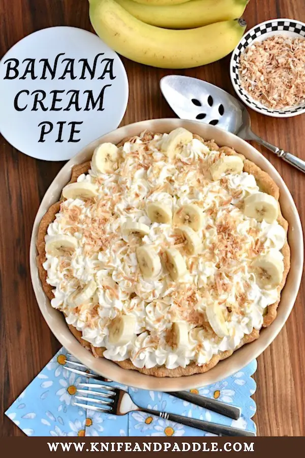 Homemade Banana Cream Pie topped with homemade whipped cream, fresh bananas and toasted coconut