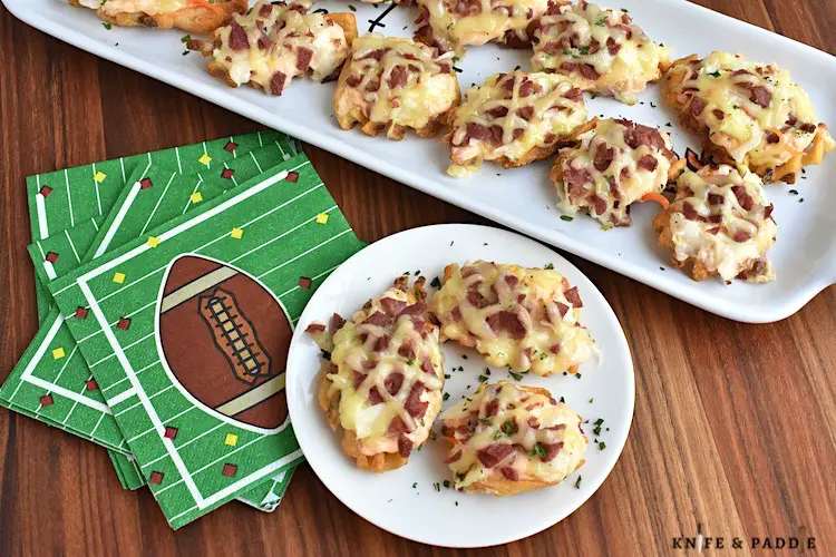 Easy game day recipe with corned beef, Swiss Cheese, Thousand Island dressing and coleslaw atop a potato