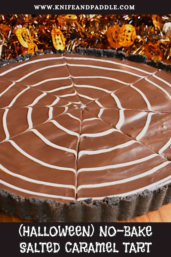 Halloween No-Bake Salted Caramel Tart with an Oreo crust and a white chocolate spider web ganache