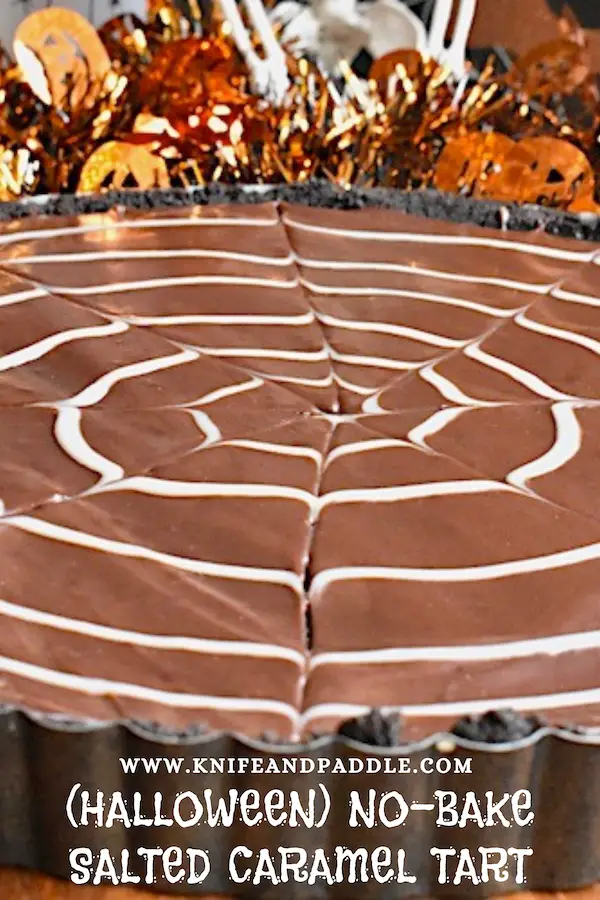 Halloween No-Bake Salted Caramel Tart with an Oreo crust and a white chocolate spider web ganache