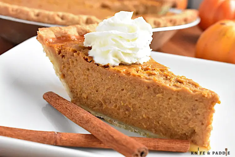 Easy Pumpkin Pie on a plate topped with whipped cream