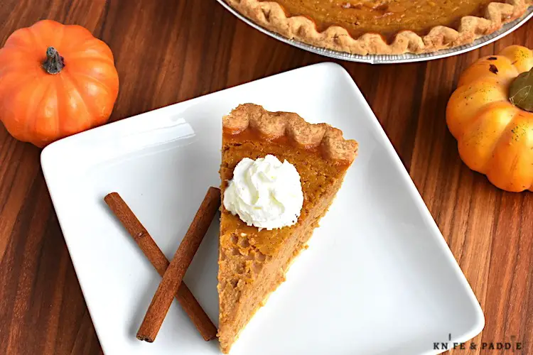 Easy Pumpkin Pie on a plate topped with whipped cream