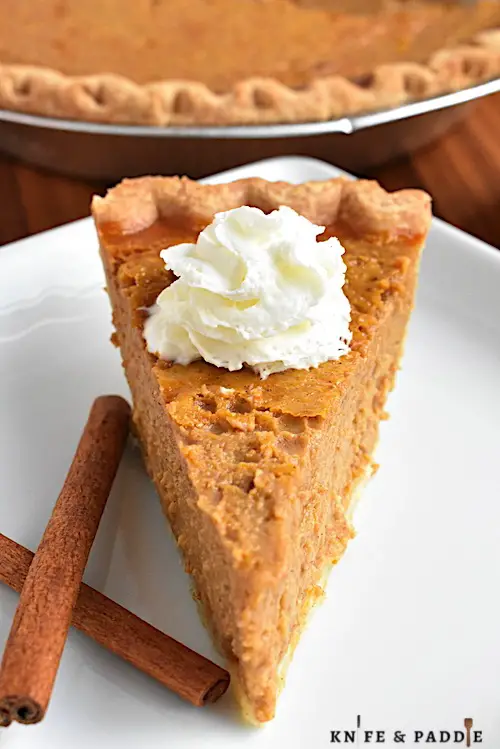 Easy Pumpkin Pie on a plate topped with whipped cream