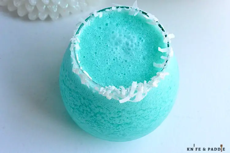 Jack Frost Cocktail with a shredded coconut rim