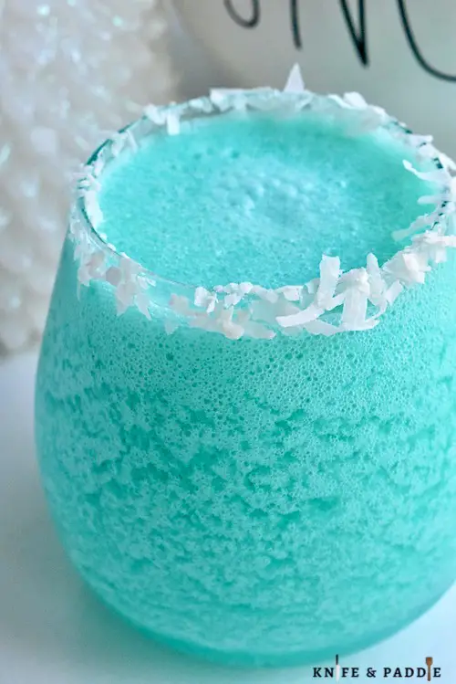 Jack Frost Cocktail with a shredded coconut rim