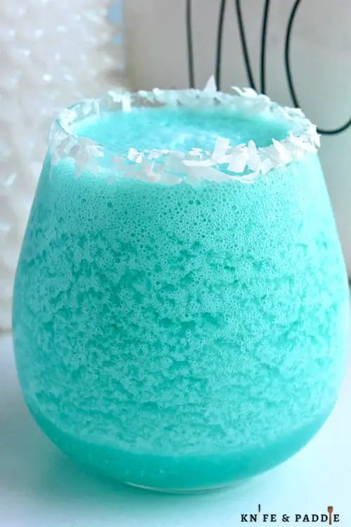 Jack Frost Cocktail with a shredded coconut rim