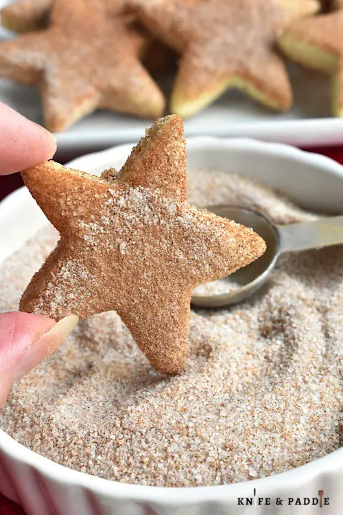 Mexican Biscochitas cut out into a star topped with cinnamon and sugar