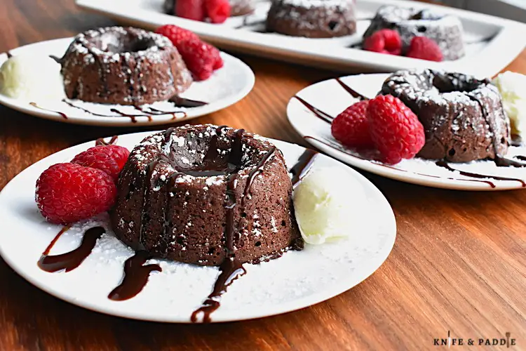 Easy Molten Chocolate Cake with chocolate sauce, raspberries and vanilla ice cream