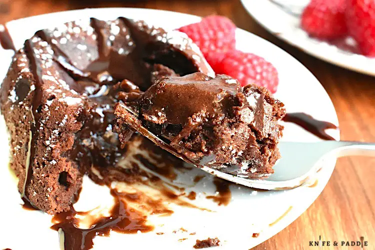 Easy Molten Chocolate Cake with chocolate sauce, raspberries and vanilla ice cream