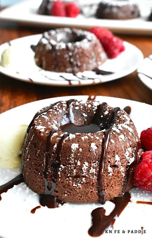 Easy Molten Chocolate Cake with chocolate sauce, raspberries and vanilla ice cream