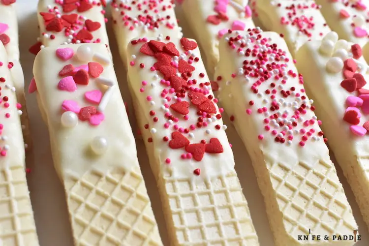 Valentine's Day Wafer Cookies topped with red and pink hearts and sprinkles