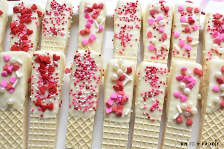 Valentine's Day Wafer Cookies topped with red and pink hearts and sprinkles