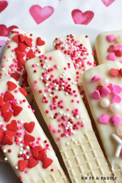 Valentine's Day Wafer Cookies topped with red and pink hearts and sprinkles