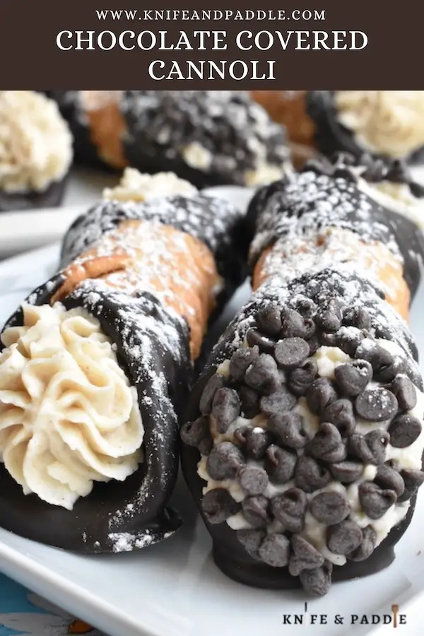 Chocolate Covered Cannoli sprinkled with powdered sugar