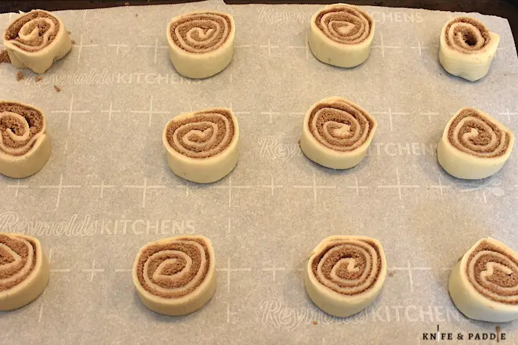 Rolled dough, pinwheels placed on a parchment lined baking sheet